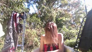 her body drips in the rain, skin glowing under the harsh light